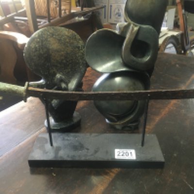 Two Shona style stone carvings Ann&#2013266057۪s a sword on stand .