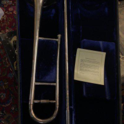 An American Chrome finished Blessing & Co trombone in a fitted case with Warranty card.