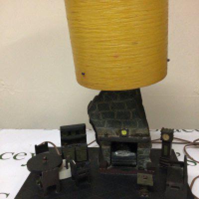 A Mid 20th Century welsh slate sculpture an interior scene with a fireplace and furniture the top with a lamp. Hight 43cm width 36cm- NO RESERVE