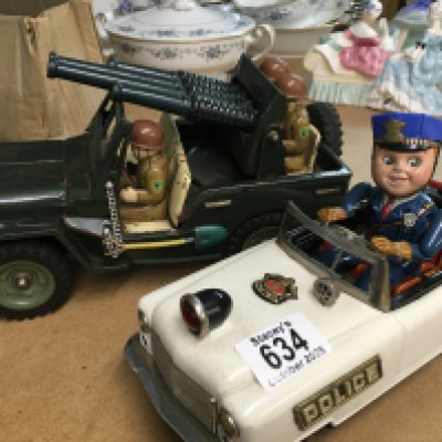 Two Japanese battery powered toys police car and army truck.