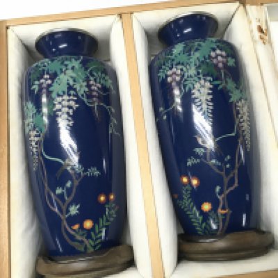 A pair of boxed 1920/30s Cloisonne vases with bird and vine decoration , also including wooden stands. 18.5cm tall approximately