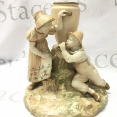 A Royal Worcester blush ivory vase of two children beside an urn, 18cm high.this lot cannot be posted