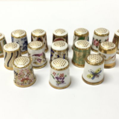 A collection of Royal Crown Derby ceramic thimbles . This lot cannot be posted
