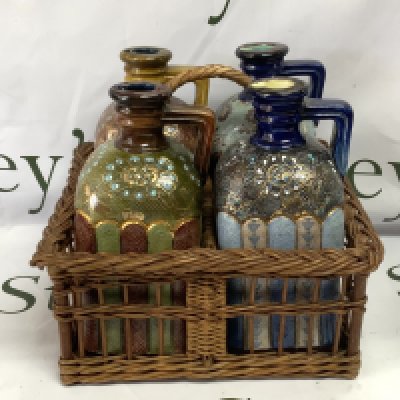 A set of 4 varied design Doulton Lambeth stoneware brandy flasks, circa 1880, square section shouldered form with angled strap handle, decorated with applied foliate bands, impressed marks, each 21cm high. Complete with wicker basket with handle. (No visable damage or restoration). Cat D, postage not avaliable for this lot.