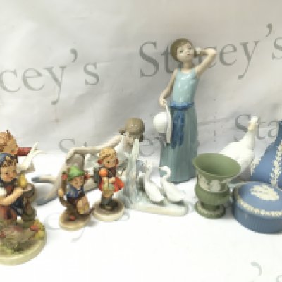 A collection of ceramic figures including Lladro, Hummel, Wedgwood vases and a trinket box . This lot cannot be posted