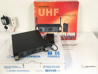 Two boxed Audio Technica series 1400:wireless systems comprising a UHF system for guitar and a wireless headset (2).