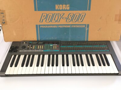 A boxed Korg Poly 800 polyphonic synthesizer. Comes with manual and stand.