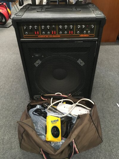 A Carlsbro Cobra 90 keyboard amplifier, a reverb pedal and various cables.