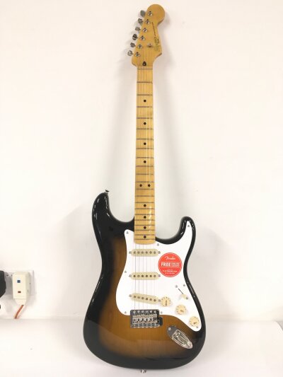 A Fender Squier Stratocaster electric guitar in two tone sunburst. Comes with soft carry case.