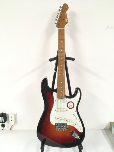 A Shijie Stratocaster style electric guitar. Brand new. Comes with soft carry case.