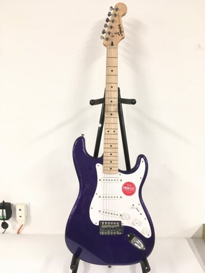 A Fender Squier Stratocaster electric guitar in a purple sparkle finish. Comes with soft carry case.
