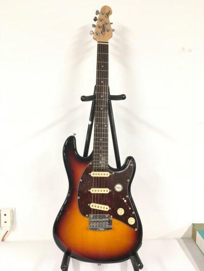 A Sterling by Music Man Cutlass electric guitar. Comes with soft padded case.