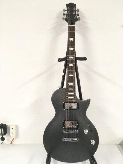 An EART electric guitar with a matt graphite finish. Comes with a soft carry case.