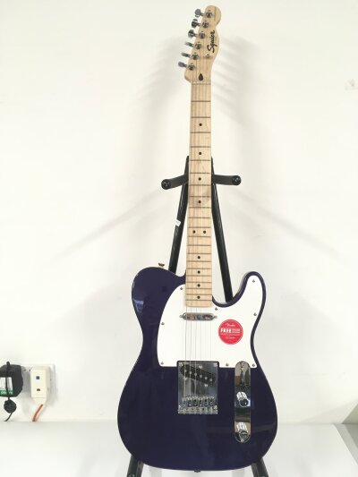 A Fender Squier telecaster electric guitar in a purple sparkle finish. Comes with a soft carry case.
