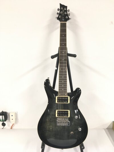 A Harley Benton CST 24 Deluxe electric guitar. Comes with soft carry case.