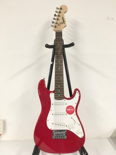 A fender Squier mini Stratocaster electric guitar in red. Perfect size for kids to learn. Brand new condition. Comes with retail box.