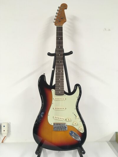 An SX VTG Series Strat style electric guitar. Comes with soft carry case.