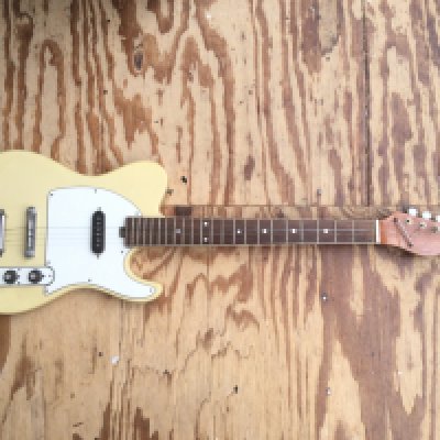 A 1964 Vox Lynx electric guitar. Semi sold thinline type with rosewood type board and block markers. This guitar comes with the rarer batwing pick guard and toaster style pickups. Being a circa 1964 guitar it was made in Italy at the Crucianella factory. Condition wise good considering age and use and has tarnishing to brightwork and some crazing in the lacquer which has aged to a nice patina. Comes with cardboard case.