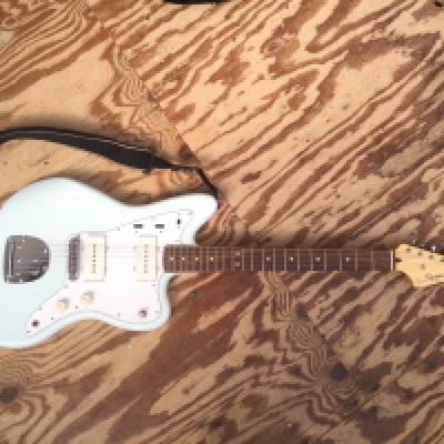 A Fender Squier Jazzmaster electric guitar in sonic blue. Comes with soft carry case.