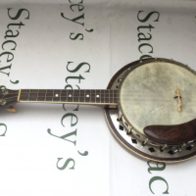 A Conqueror banjolele with soft carry case.