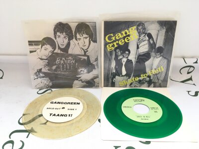 Two Gang Green 7" singles on coloured vinyl comprising Sold Out and Skate To Hell. Both EX.