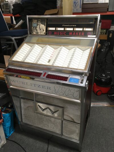 A Wurlitzer 2700 series jukebox. Powers up but not functioning properly. Contains a full complement of 7" singles. Comes with manual, no key.