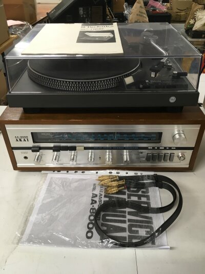A Technics SL1900 record player and an Akai AA-8000 solid state stereo receiver. Both come with user manuals and connector leads.