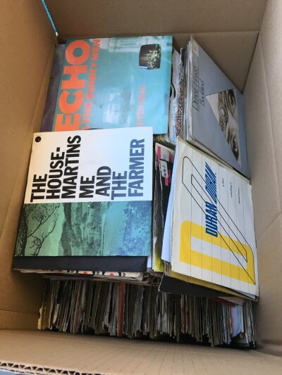 A box of 7" singles by various artists including The Rolling Stones, Echo & The Bunnymen, Duran Duran and many more.