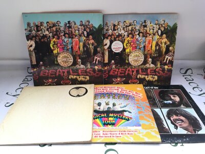 Five Beatles LPs comprising two coloured vinyl pressings of Sgt Pepper, a French white vinyl pressing of the White Album and others.