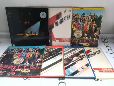 Seven Beatles and related LPs comprising coloured vinyl pressings of Sgt Pepper, the red and blue albums and others.
