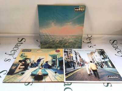 Three first UK pressings of Oasis records comprising the Definitely Maybe and (What's The Story) Morning Glory? LPs plus the Whatever 12" single. Both LPs are Damont pressings. All vinyl EX, sleeves generally VG+.