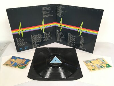 A first UK solid blue triangle label pressing of Pink Floyd's Dark Side Of The Moon LP. Complete with original inner sleeve, both posters and both stickers, gatefold UK 1973 SHVL 804. Vinyl NM, sleeve VG+.