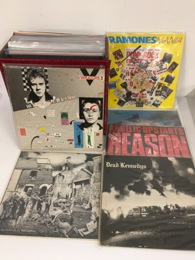 A record case of punk LPs by various artists including Dead Kennedys, Vibrators, Crass and others.
