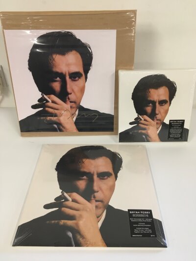 A sealed Bryan Ferry - Retrospective 2LP half speed mastered compilation plus a 5CD deluxe edition of the same album plus a signed 12" x 12" photo of the cover art.