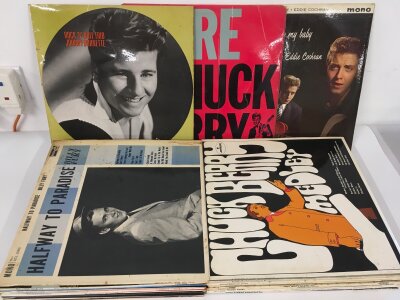 A record case of rock n roll LPs and 78s by various artists including Eddie Cochran, Johnny Burnette, Billy Fury and others.