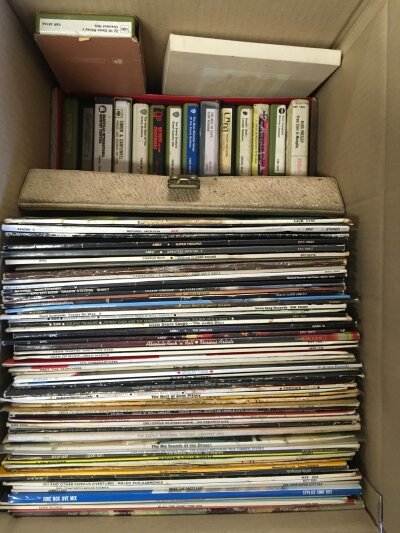 A box of LPs and 8 track cartridges plus some 7" picture and company sleeves.