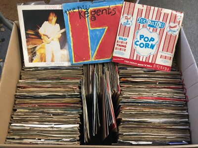 Two boxes of 7" singles by various artists including Sex Pistols, David Bowie, Queen, Black Sabbath and many more.