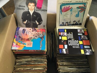 Two boxes of 7" and 12" singles by various artists including Bob Marley, The Clash, John Lennon, Television and many more.