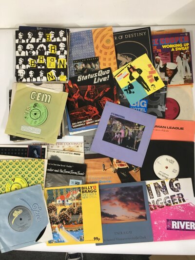 A small collection of 7" singles by various artists including Devo, Alice Cooper, Billy Bragg and others including some promos and demo discs.