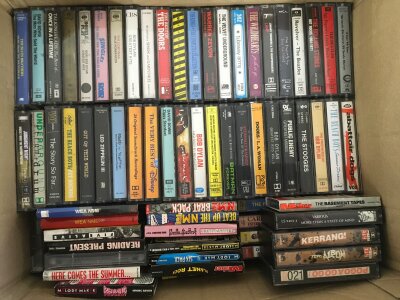 Two boxes of cassettes comprising many punk, grunge, alt rock bands including Black Flag, Pavement, Red Hot Chili Peppers, Metallica, Oasis and many more.