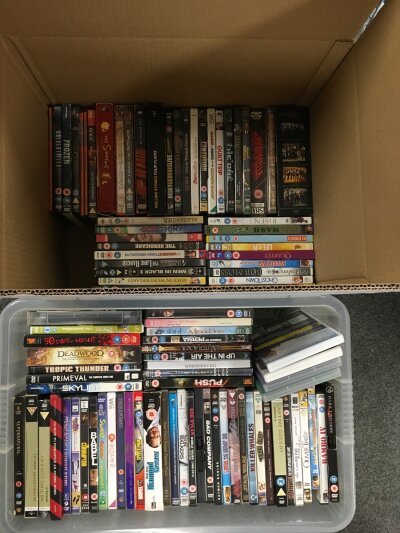 Seven boxes containing a large collection of DVDs and BluRays.