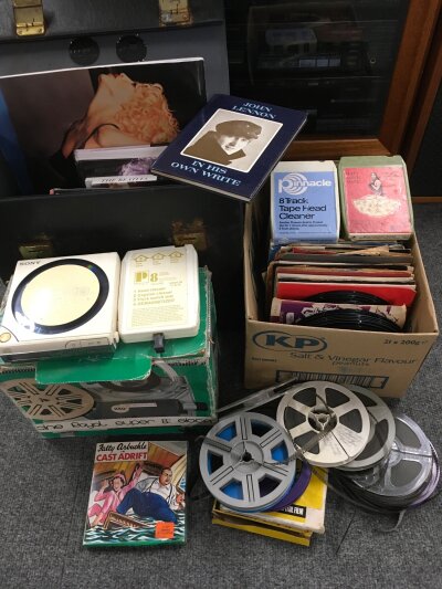 A collection of 7" singles by various artists from the 1960s onwards plus a boxed Super 8 camera and reels and a selection of music books.