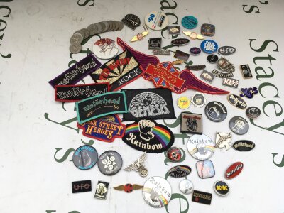 A collection of vintage badges, buttons and sew on patches for various rock groups including Motörhead, Kiss, Judas Priest and others.