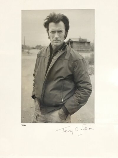 Terry O'Neill CBE 1938-2019. A framed and glazed limited edition gelatin silver print of Clint Eastwood signed and numbered by Terry O'Neill to the mount, 7/150. Approx size including frame 38cm x 46cm.