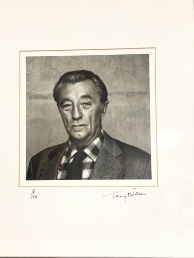 Terry O'Neill CBE 1938-2019. A framed and glazed limited edition gelatin silver print of Robert Mitchum signed and numbered by Terry O'Neill to the mount, 5/150. Approx size including frame 38cm x 46cm.
