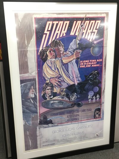 A framed Star Wars one sheet style D film poster, 2007 reproduction, approx 84cm x 120cm including frame.