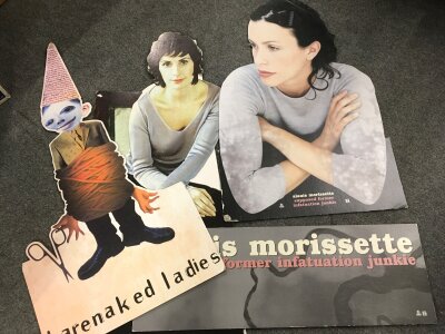 A collection of music standees and posters for various artists including Alanis Morissette, Barenaked Ladies etc.