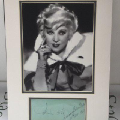 A framed and signed display of Mae West with COA, approx 30cm x 40cm.