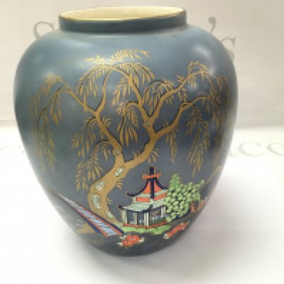 An Art Deco vase with an oriental painted scene. 20cm tall.