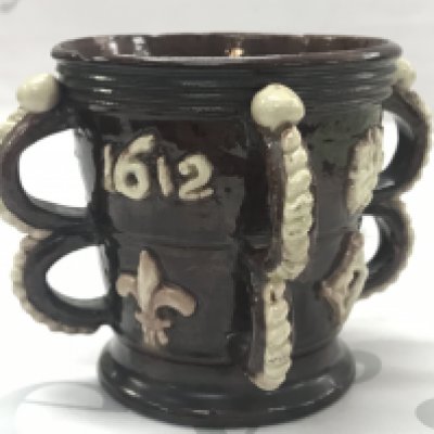 A Castle Hedingham four handled jug , some damage. this lot cannot be posted